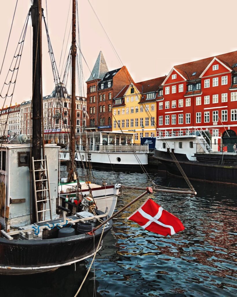 Boat in a river with Danish flag, scandinavian languages comparison