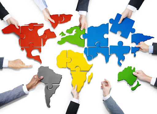 Group of Business People with Jigsaw Puzzle of the World Map representing a Language Service Provider 